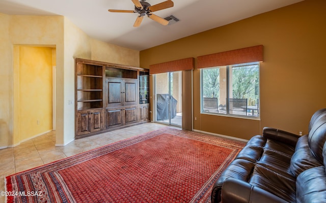 unfurnished living room with light tile patterned flooring, ceiling fan, visible vents, and baseboards