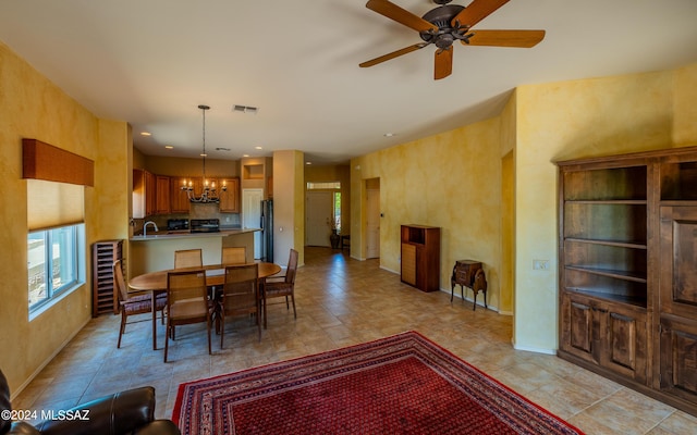 dining area with baseboards, visible vents, and ceiling fan with notable chandelier