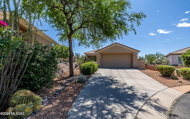 view of front of property featuring concrete driveway, an attached garage, and stucco siding