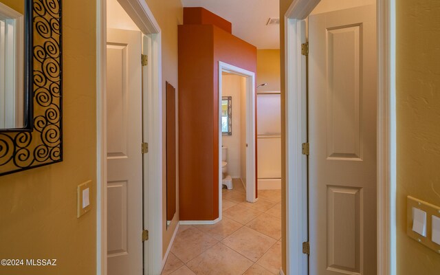 hallway featuring light tile patterned flooring