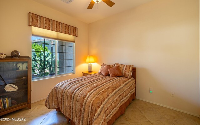 bedroom featuring ceiling fan and tile patterned flooring