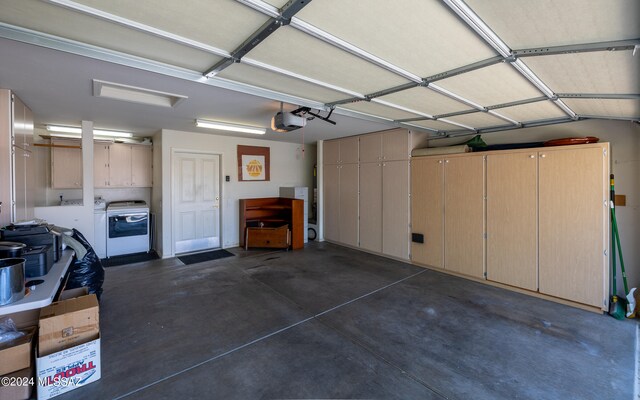 garage with washer / dryer and a garage door opener