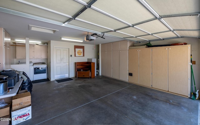 garage with washer / clothes dryer and a garage door opener