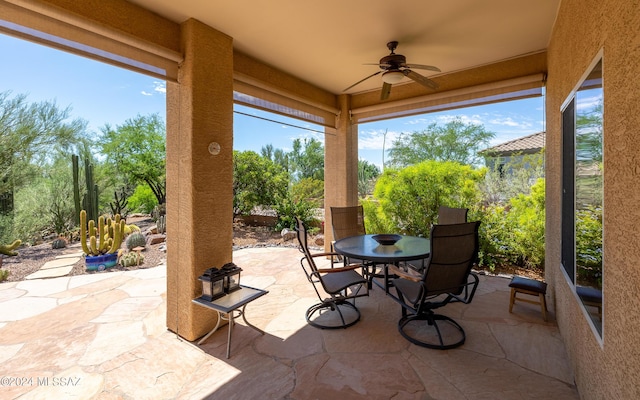 view of patio featuring ceiling fan and outdoor dining area