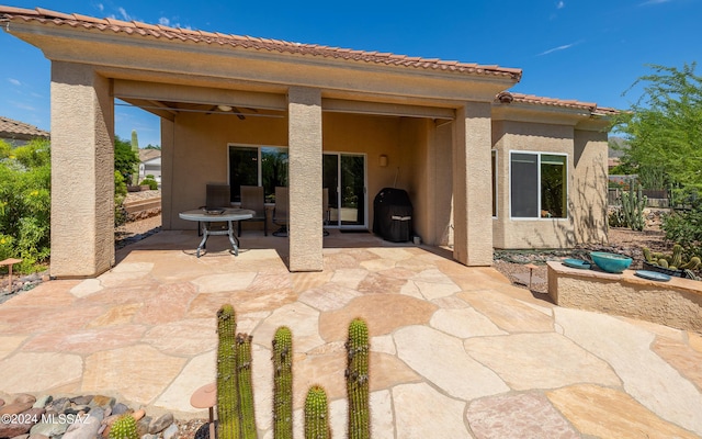 view of patio / terrace with ceiling fan and a grill