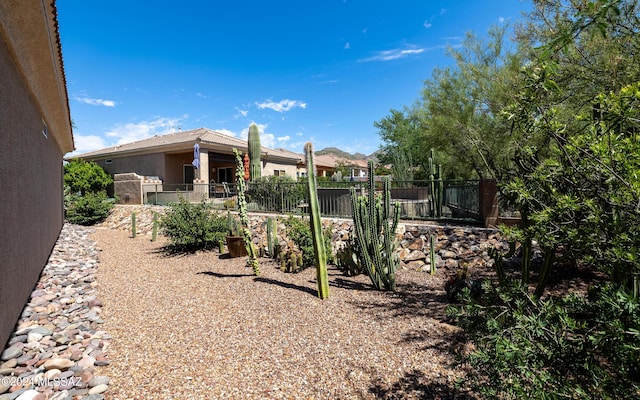 rear view of house featuring fence and stucco siding