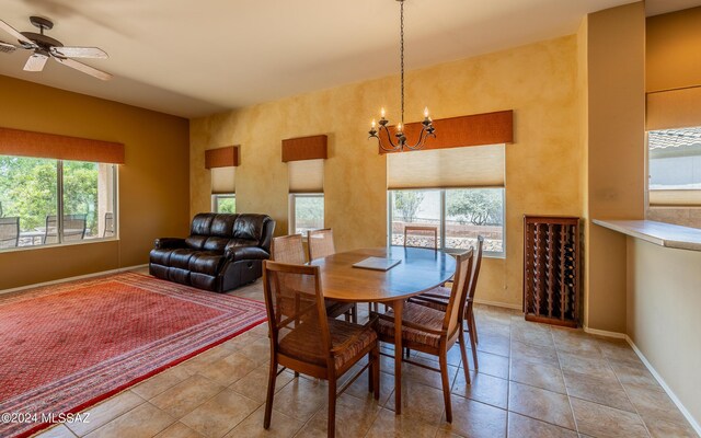 dining room with ceiling fan with notable chandelier and light tile patterned floors