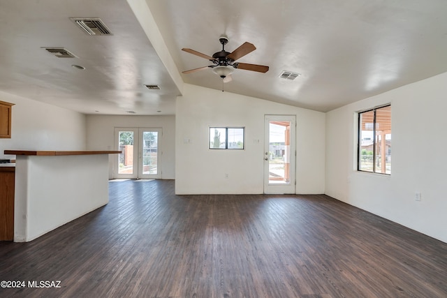 unfurnished living room with french doors, ceiling fan, dark hardwood / wood-style floors, and vaulted ceiling