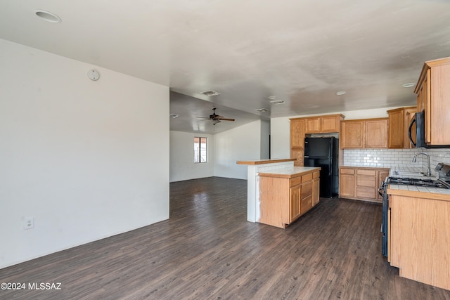 kitchen featuring black appliances, ceiling fan, dark hardwood / wood-style floors, and tile countertops