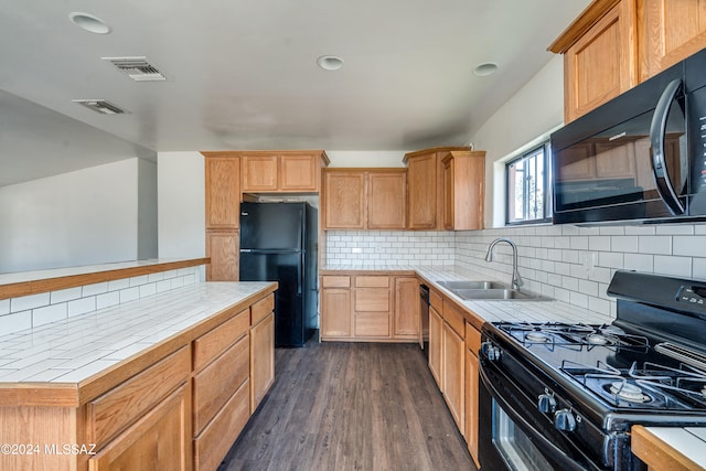 kitchen featuring black appliances, backsplash, sink, and dark hardwood / wood-style floors