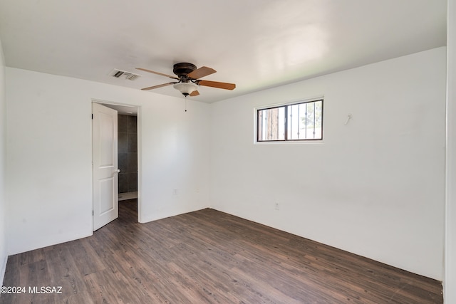 spare room featuring ceiling fan and dark hardwood / wood-style floors