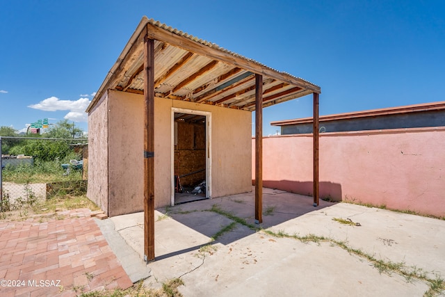 view of patio with a storage unit