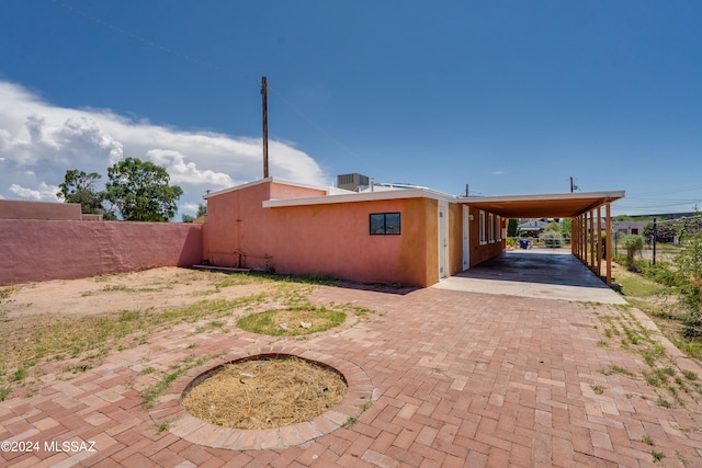 rear view of house featuring a carport