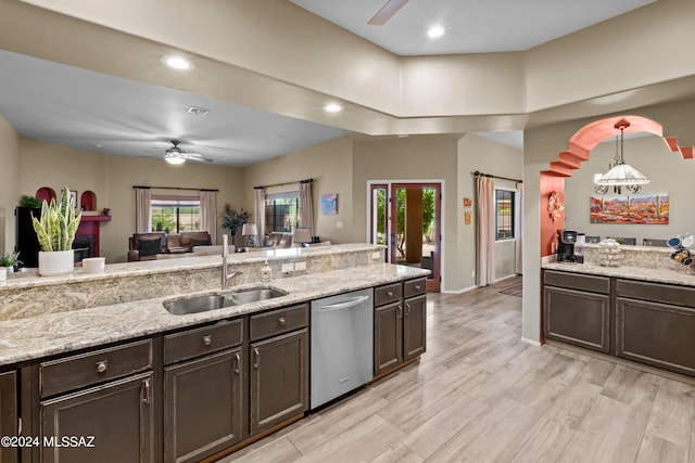 kitchen with dishwasher, light stone countertops, sink, and ceiling fan