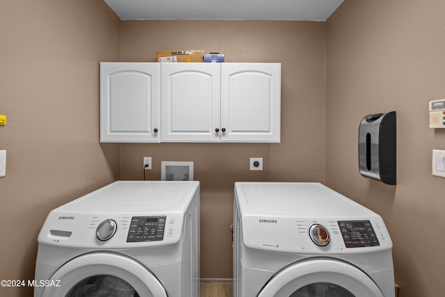 laundry room with cabinets and washing machine and dryer