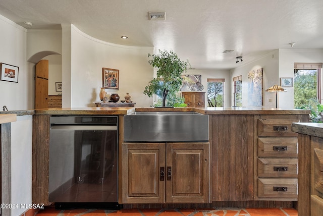 kitchen featuring ornamental molding, dark tile patterned floors, and sink