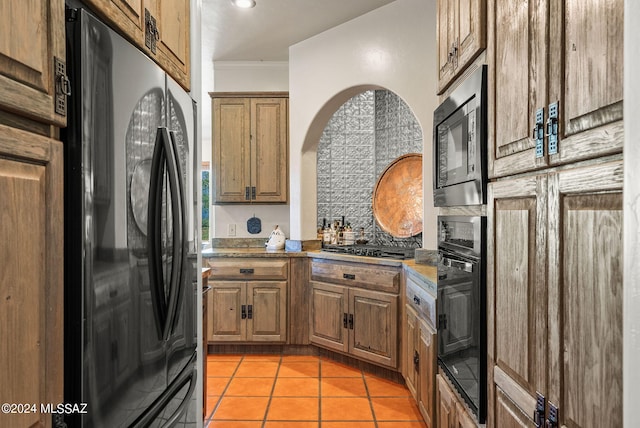 kitchen with ornamental molding, stainless steel appliances, light tile patterned floors, and tasteful backsplash