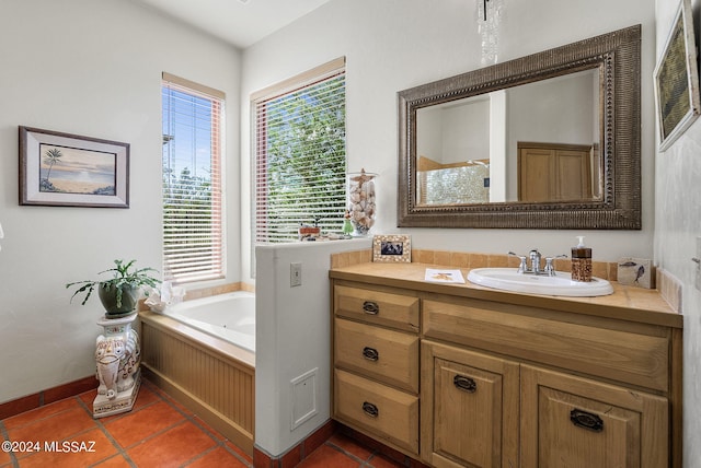 bathroom featuring a bathing tub, tile patterned flooring, and vanity