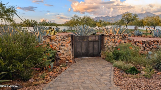 gate at dusk featuring a mountain view