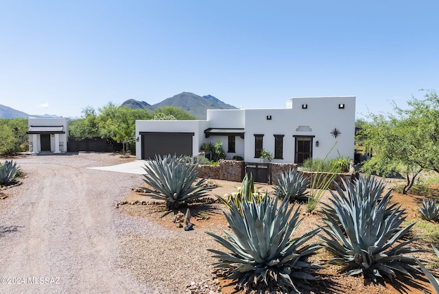 southwest-style home with a mountain view and a garage