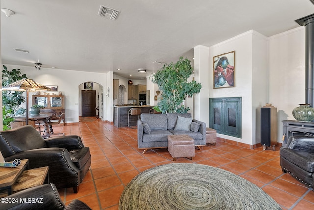 living room featuring crown molding and tile patterned floors