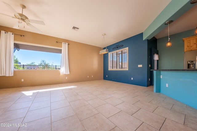 empty room featuring light tile patterned flooring and ceiling fan