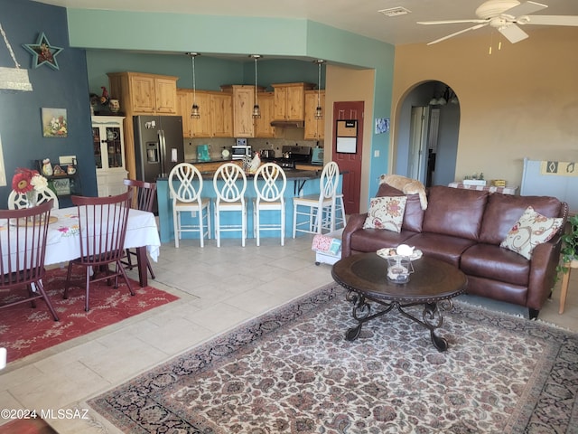 tiled living room with ceiling fan