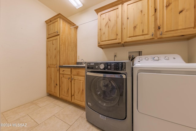 laundry area featuring cabinets and washer and dryer