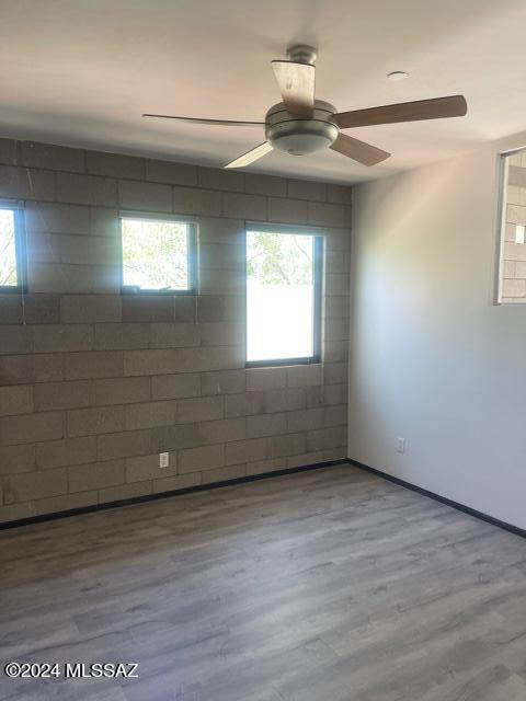 spare room featuring ceiling fan and wood-type flooring