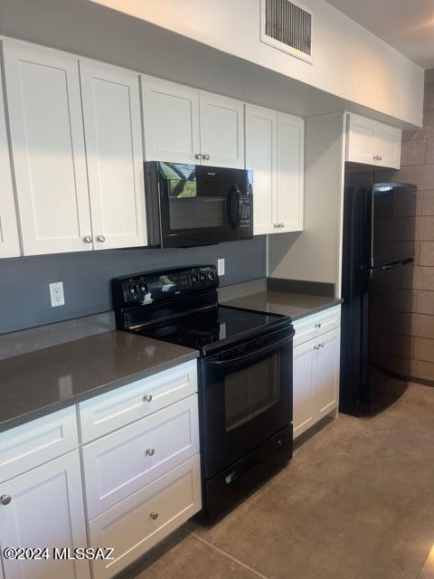 kitchen with white cabinets and black appliances