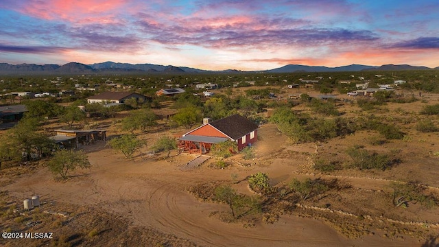 aerial view at dusk featuring a mountain view