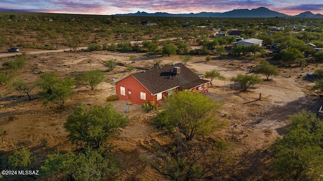 aerial view at dusk featuring a mountain view