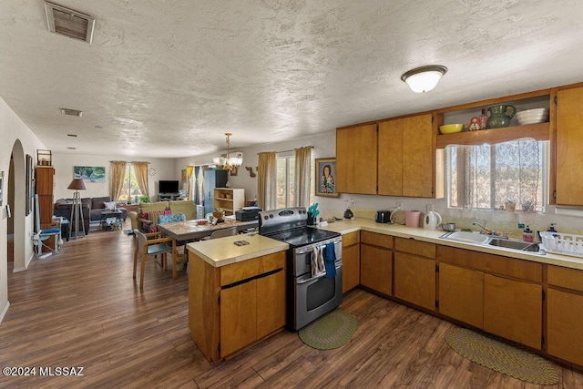 kitchen with stainless steel electric stove, a healthy amount of sunlight, kitchen peninsula, and sink