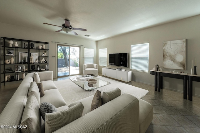 tiled living area with ceiling fan, visible vents, and baseboards