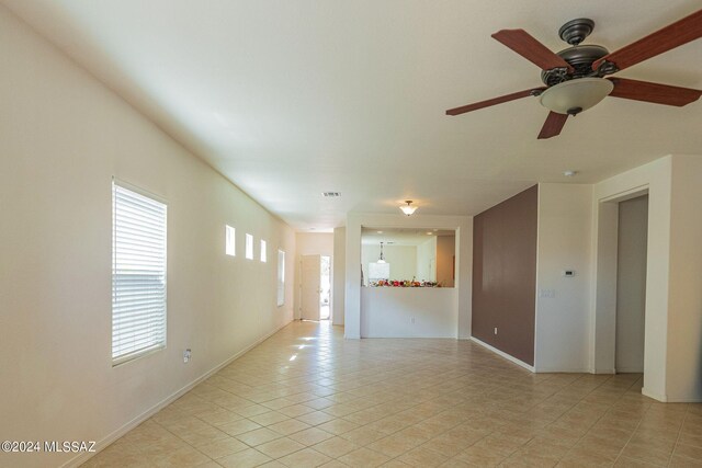 tiled empty room with ceiling fan