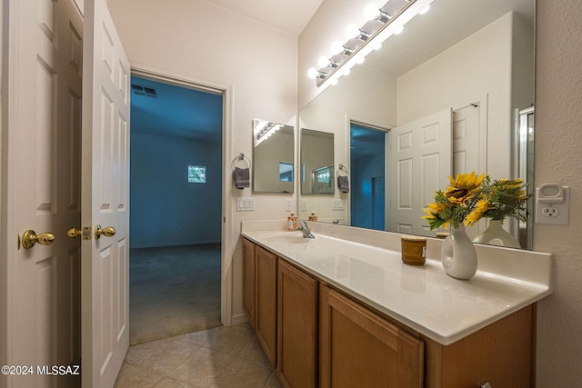 bathroom with visible vents, vanity, and tile patterned floors