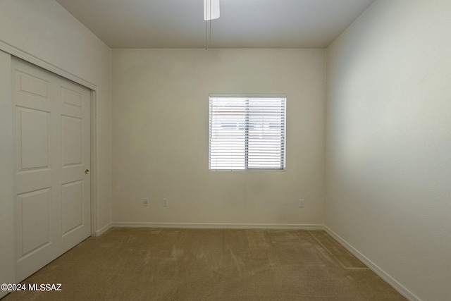 interior space with a closet and light carpet