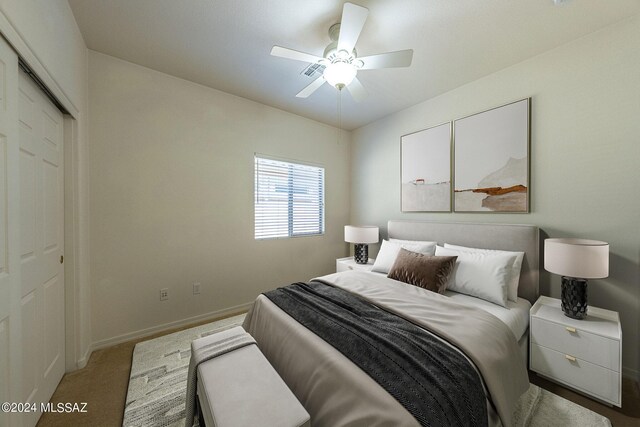 carpeted bedroom featuring ceiling fan and a closet