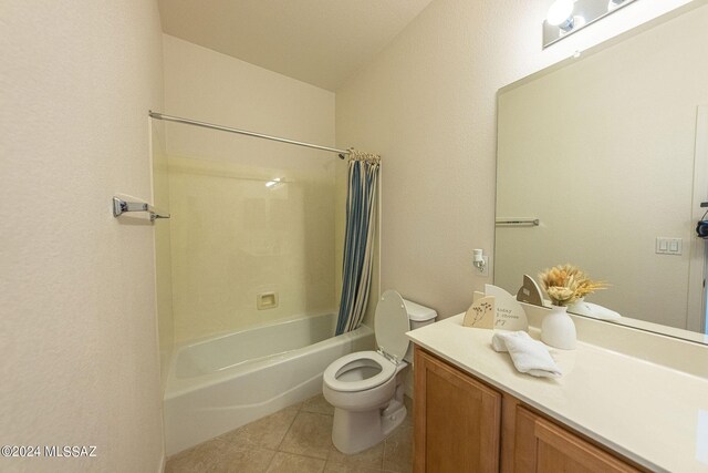 full bathroom with vanity, toilet, tile patterned floors, and shower / bath combo with shower curtain