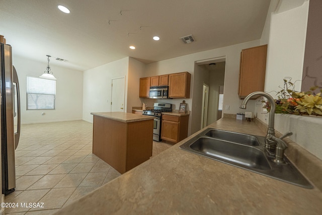 kitchen with a kitchen island, light tile patterned floors, appliances with stainless steel finishes, hanging light fixtures, and sink