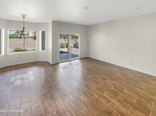 spare room featuring wood finished floors and baseboards