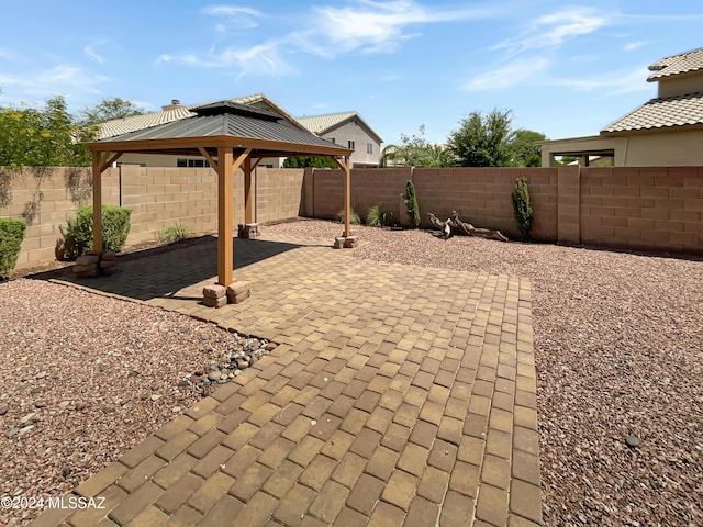 view of patio featuring a fenced backyard and a gazebo