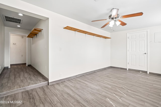 spare room featuring light hardwood / wood-style floors and ceiling fan