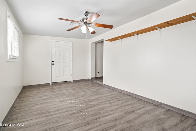 unfurnished room featuring light wood-type flooring and ceiling fan