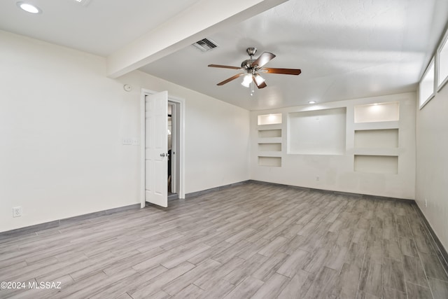 unfurnished living room with built in features, light wood-type flooring, and ceiling fan