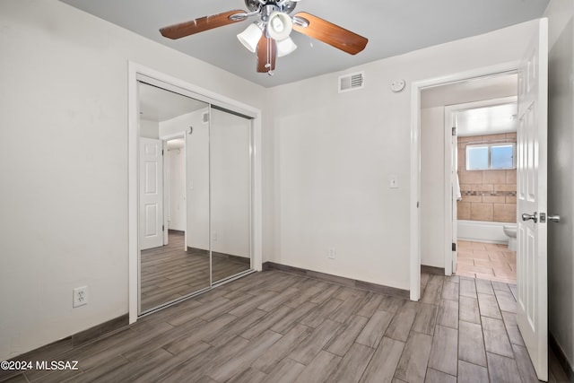 unfurnished bedroom featuring a closet, light wood-type flooring, and ceiling fan