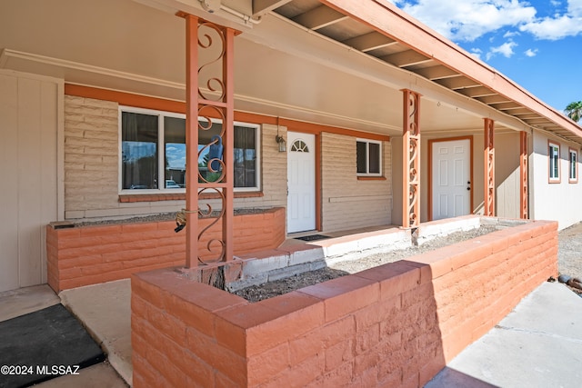 view of exterior entry featuring a porch