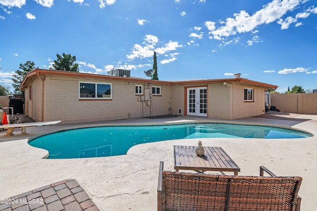 view of swimming pool with a patio area and french doors