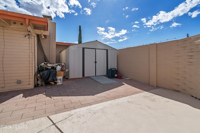 view of patio featuring a shed