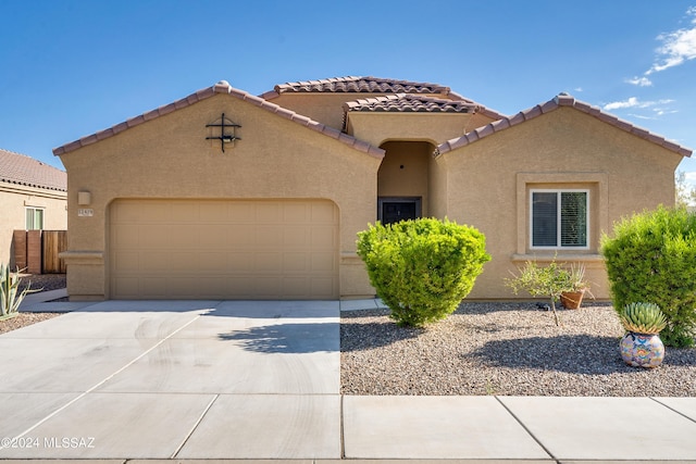 mediterranean / spanish home with driveway, a garage, and stucco siding